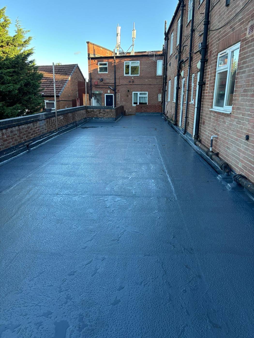 Completed liquid roofing system with reinforcement matting personally completed by Harris Roof Systems